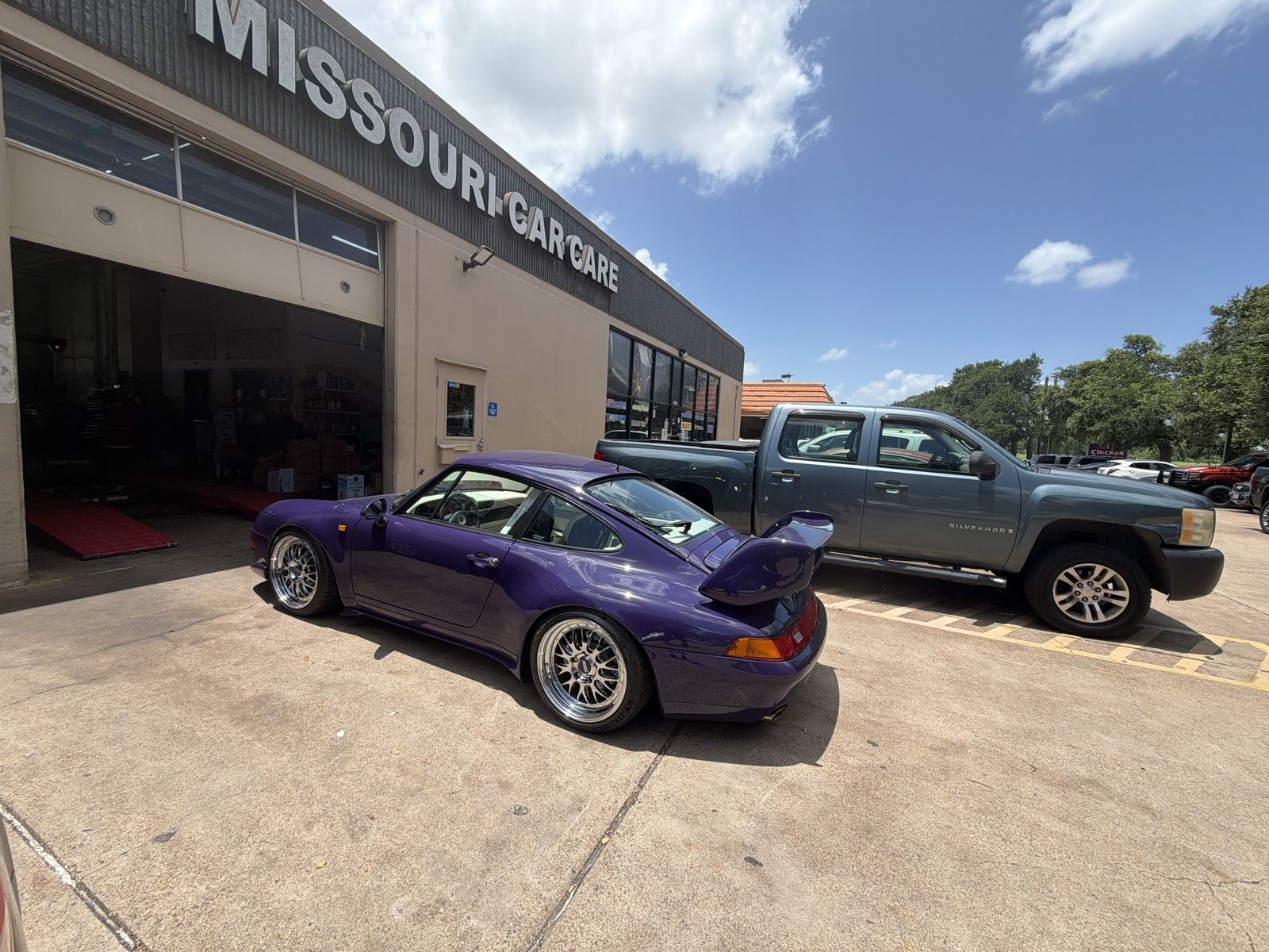 Purple Porsche 993 parked in front of Missouri Car Care