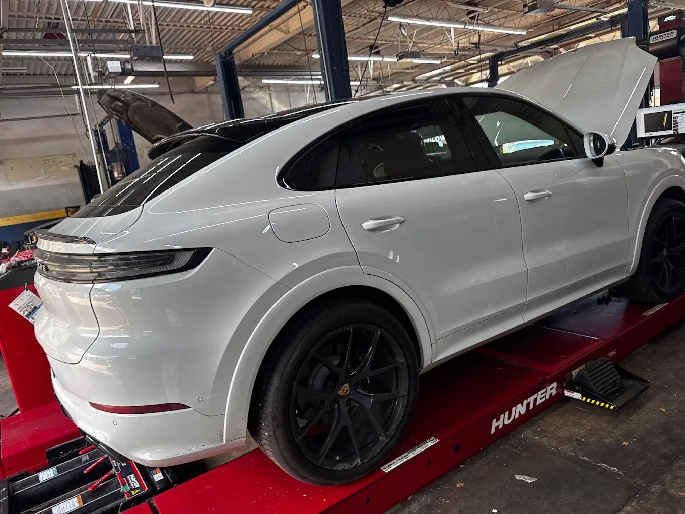 White Porsche Cayenne Coupe on the Hunter alignment rack