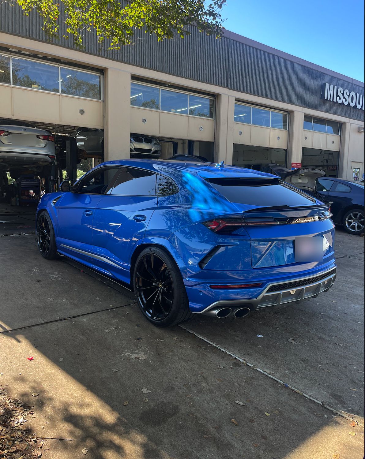 Lamborghini Urus in front of the service bays